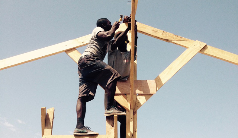 Haitian youth erect the frame for a hempcrete building project near Port au Prince