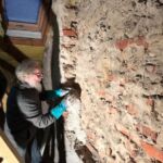 Wolf demonstrates interior insulation of exterior wall.
